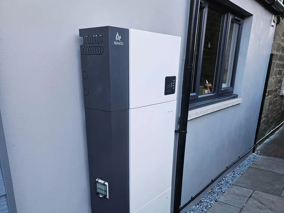 AlphaESS battery installed beside a window on a rendered house wall