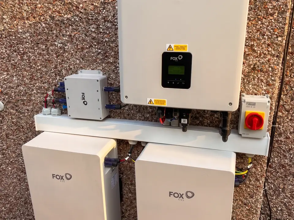 Fox ESS inverter and two battery modules installed on an exterior wall