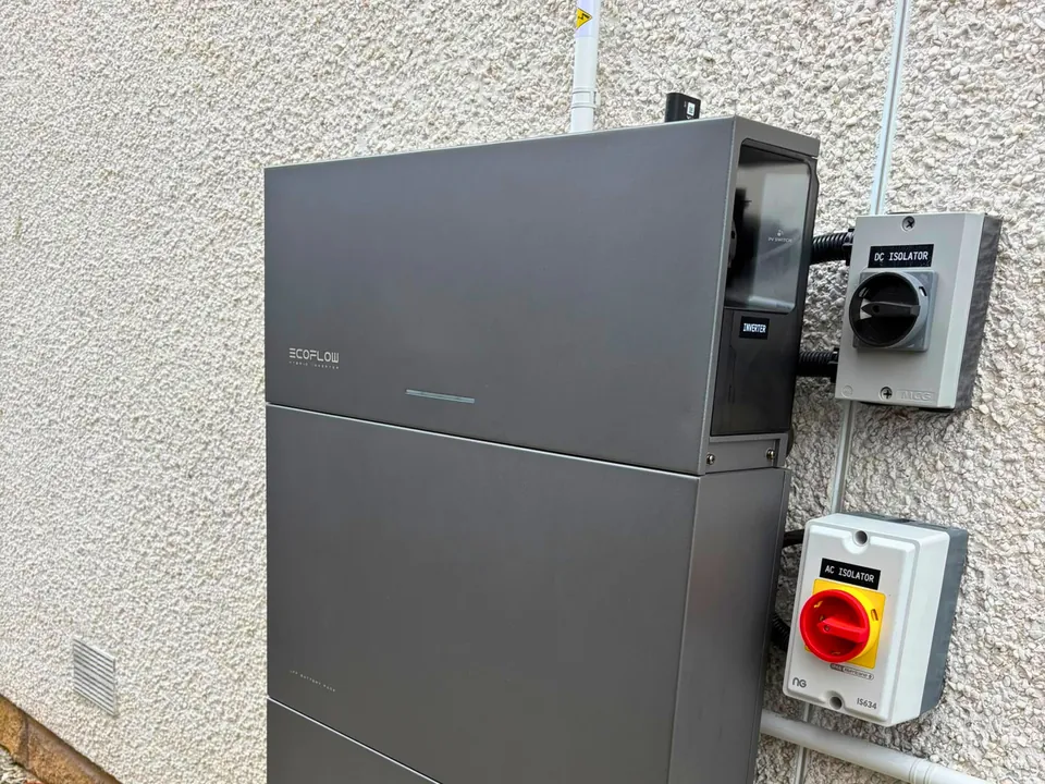 An EcoFlow home battery installed by Viking on an outside wall, with its isolator switches beside it