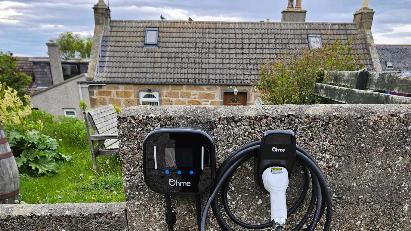 Two Ohme EV chargers installed on a garden wall at a Scottish home
